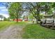Exterior view showing multiple barns on grassy, tree-lined acreage at 12471 N 100 E, Alexandria, IN 46001