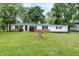 Charming single-story home with a green metal roof, fresh white paint, and a well-maintained lawn at 12471 N 100 E, Alexandria, IN 46001