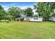 Charming single-story home with a green metal roof, fresh white paint, and a well-maintained lawn at 12471 N 100 E, Alexandria, IN 46001