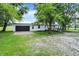 Ranch house with white siding, black garage door, and handicap ramp at 12471 N 100 E, Alexandria, IN 46001