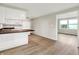 Bright kitchen featuring white cabinets, hardwood floors, and an open design that flows seamlessly into the living space at 12471 N 100 E, Alexandria, IN 46001