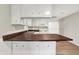 Well-lit kitchen includes wood countertops and sleek white cabinetry at 12471 N 100 E, Alexandria, IN 46001