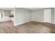 Clean and well-lit living room with hardwood floors, connecting to a kitchen area with white cabinets at 12471 N 100 E, Alexandria, IN 46001
