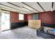A room with a concrete floor, wood paneling and black trim with a bright window at 12471 N 100 E, Alexandria, IN 46001