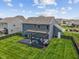Spacious backyard showcasing a dark wooden deck, cozy pergola, and well-maintained lawn at 1306 Avocet Dr, Greenwood, IN 46143