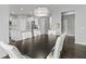 Dining room with long table and seating, open to the kitchen with white cabinetry at 1306 Avocet Dr, Greenwood, IN 46143