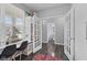Bright flex room features hardwood floors, large window, built in storage, and glass panel french doors at 1306 Avocet Dr, Greenwood, IN 46143