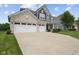 Well-maintained two-story home with three car garage, and manicured lawn at 1306 Avocet Dr, Greenwood, IN 46143