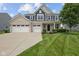 Beautiful home with a well-kept lawn and an attached three-car garage at 1306 Avocet Dr, Greenwood, IN 46143