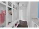 Mudroom-style hallway with white storage cubbies and dark wood floors at 1306 Avocet Dr, Greenwood, IN 46143