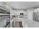 Bright kitchen featuring white cabinetry, granite countertops, stainless steel appliances, and a large island at 1306 Avocet Dr, Greenwood, IN 46143