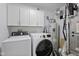 Functional laundry room with new front loading washer and dryer and ample storage space at 1306 Avocet Dr, Greenwood, IN 46143