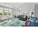Open-concept living room featuring stylish furniture, chandelier, and large windows at 1306 Avocet Dr, Greenwood, IN 46143