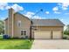 Exterior view of home's rear with a basketball court and multiple garage doors, highlighting the home's recreational space at 13191 Roma, Carmel, IN 46074