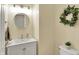 Bathroom featuring a white vanity, round mirror, and modern lighting at 13191 Roma, Carmel, IN 46074