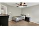 Modern bedroom with a black bed frame, ceiling fan, and neutral walls, offering a minimalist aesthetic at 13191 Roma, Carmel, IN 46074