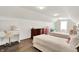 Bright bedroom featuring two twin beds, wood floors, a vanity, and ample natural light at 13191 Roma, Carmel, IN 46074