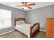 Cozy bedroom featuring a wooden bed frame, ceiling fan, and neutral-colored walls at 13191 Roma, Carmel, IN 46074