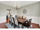 A dining room featuring hardwood floors, a chandelier, and a dining table with eight chairs at 13191 Roma, Carmel, IN 46074