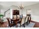 A dining room featuring hardwood floors, a chandelier, and a dining table with several chairs at 13191 Roma, Carmel, IN 46074