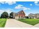 View of the home featuring a large driveway, lush grass and a basketball hoop at 13191 Roma, Carmel, IN 46074