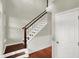 View of foyer featuring wood floors, paneled walls and stairs with wood trim at 13191 Roma, Carmel, IN 46074