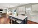 Bright kitchen featuring stainless steel appliances, white cabinets, and a center island with barstool seating at 13191 Roma, Carmel, IN 46074