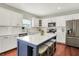 A spacious kitchen with white cabinets, stainless steel appliances, and a center island at 13191 Roma, Carmel, IN 46074
