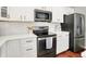 Modern kitchen features white cabinetry, stainless steel appliances, and quartz countertops at 13191 Roma, Carmel, IN 46074