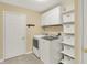 Well-organized laundry room featuring a washer, dryer, and shelving at 13191 Roma, Carmel, IN 46074