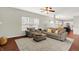 Comfortable living room with neutral furniture, area rug, and ceiling fan at 13191 Roma, Carmel, IN 46074
