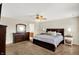 Spacious main bedroom with a large bed, dresser, and a view into the bathroom, showcasing an open layout at 13191 Roma, Carmel, IN 46074