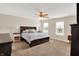 Inviting main bedroom with a ceiling fan, carpeted floors, and a large bed, creating a relaxing retreat at 13191 Roma, Carmel, IN 46074