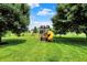 Backyard playground featuring a slide, climbing area, and swing set, perfect for outdoor fun at 13191 Roma, Carmel, IN 46074
