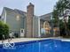 Back exterior view of house featuring a refreshing pool and an expansive backyard at 13262 Landwood Dr, Fishers, IN 46037