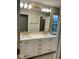 Bathroom featuring double sinks, a large mirror, and storage beneath the countertop at 13262 Landwood Dr, Fishers, IN 46037