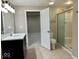 Bathroom with double vanity, tiled floor, glass shower, and view of bedroom at 13262 Landwood Dr, Fishers, IN 46037