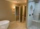 Modern bathroom with soaking tub, glass shower, and marble tile at 13262 Landwood Dr, Fishers, IN 46037
