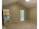 Spacious bedroom with vaulted ceilings, neutral carpeting, and ensuite bathroom access at 13262 Landwood Dr, Fishers, IN 46037
