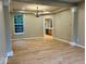 Spacious dining room featuring gleaming hardwood floors, recessed lights, and classic chandelier at 13262 Landwood Dr, Fishers, IN 46037