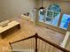 Bright living room featuring many windows, a fan, hardwood floors, and a kitchen island at 13262 Landwood Dr, Fishers, IN 46037