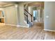 Open-concept living room featuring a staircase and a glimpse into the bathroom and kitchen at 13262 Landwood Dr, Fishers, IN 46037
