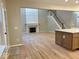 Open-concept living room featuring a fireplace, wood floors, and stairs at 13262 Landwood Dr, Fishers, IN 46037