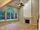 Bright living room with a vaulted ceiling, modern fireplace, and large windows at 13262 Landwood Dr, Fishers, IN 46037