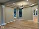 Bright living room with hardwood floors, large windows, and elegant chandelier lighting at 13262 Landwood Dr, Fishers, IN 46037