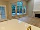 Open living space featuring a fireplace, hardwood floors, and views of the pool outside the windows at 13262 Landwood Dr, Fishers, IN 46037