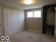 Bedroom featuring carpeted floors, window, and closet with multiple hinged doors for ample storage at 1333 S B St, Elwood, IN 46036