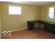 Bedroom featuring hardwood floors, natural light from two windows, and a built-in desk at 1333 S B St, Elwood, IN 46036