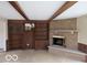 Living room with brick fireplace, wood beams, and built-in shelving offering both style and functionality at 1333 S B St, Elwood, IN 46036