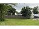 Spacious backyard with a wooden fence and lush green grass, surrounded by mature trees at 1352 S County Road 850 W, Greensburg, IN 47240